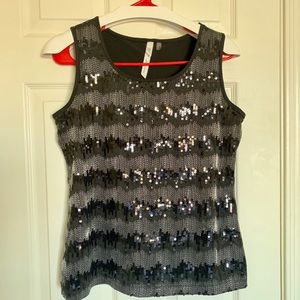 Black shiny medium size sleeveless top .